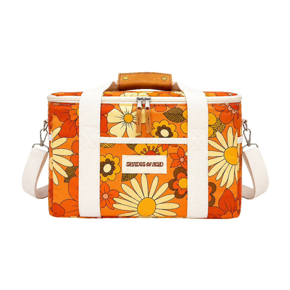 An orange daisy-patterned cooler bag with white straps, a brown leather handle, and a silver zipper, shown on a plain white background.