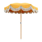 A yellow patio umbrella with a scalloped fringe trim and a floral patterned underside, supported by a wooden pole on a plain white background.