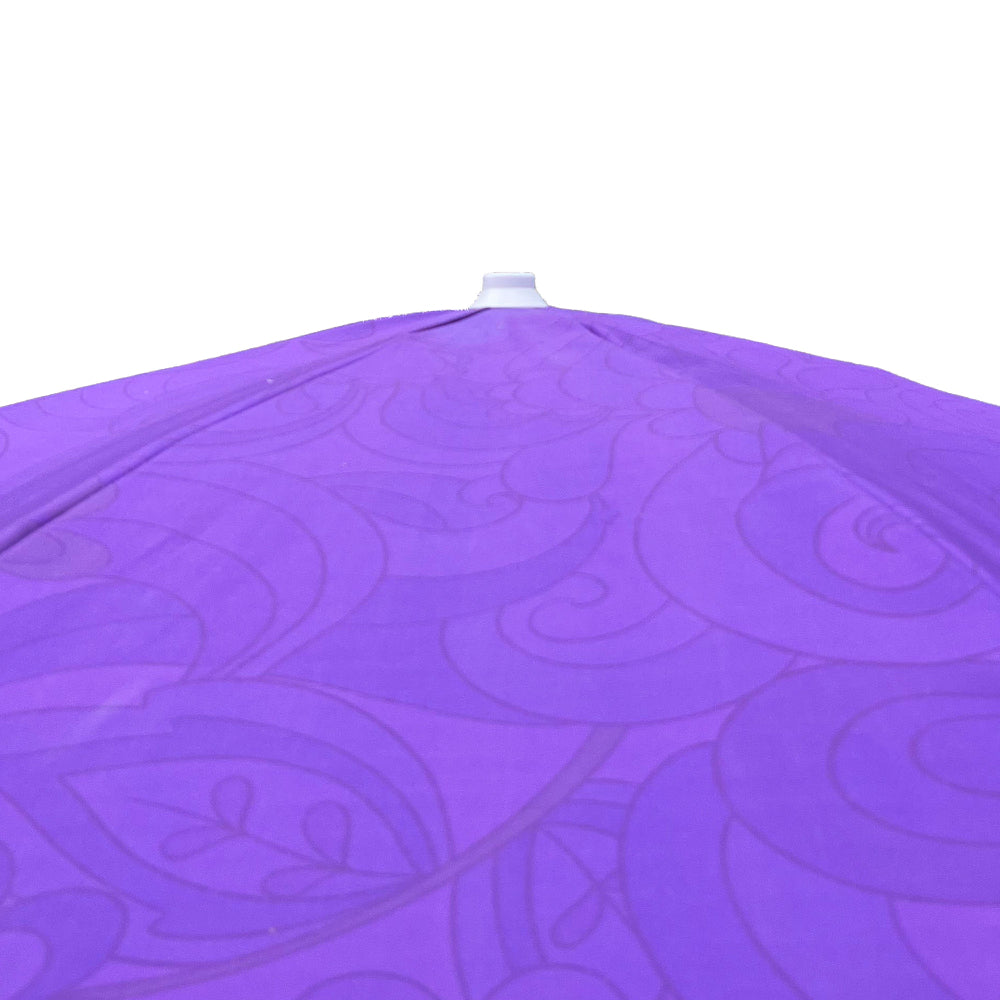 A close-up of a purple patio umbrella canopy with a subtle tonal swirl pattern, showing the fabric texture and the top finial against a white background.