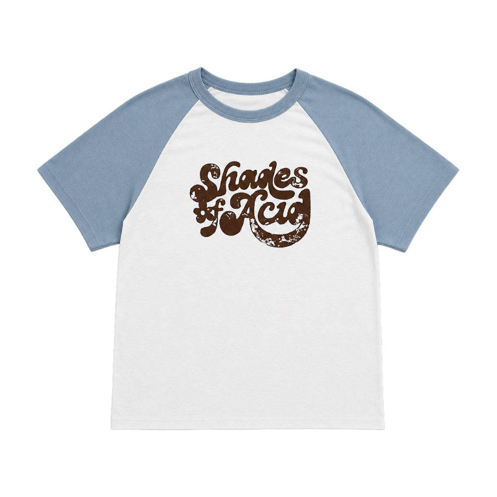 A raglan-style short-sleeve t-shirt with a white body and light blue sleeves, featuring a distressed brown graphic on the chest that reads 'Shades of Acid'.